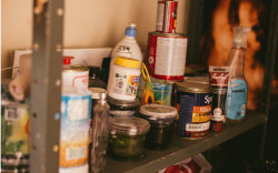 Household Hazardous Waste: household cleaners and paint cans sit on a shelf 