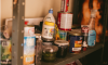 Household Hazardous Waste: household cleaners and paint cans sit on a shelf 